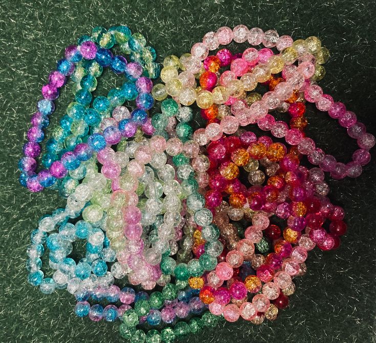 several different colored beads are on the ground next to each other, with one beaded in