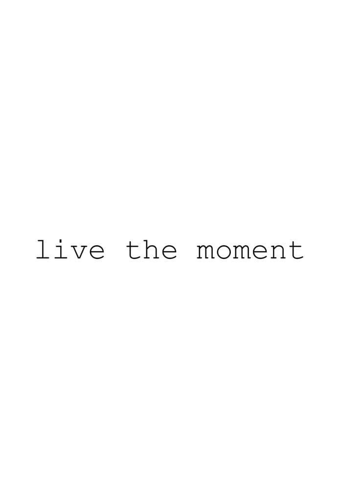 the words live the moment are in black and white