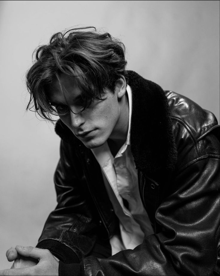 black and white photograph of a young man wearing a leather jacket