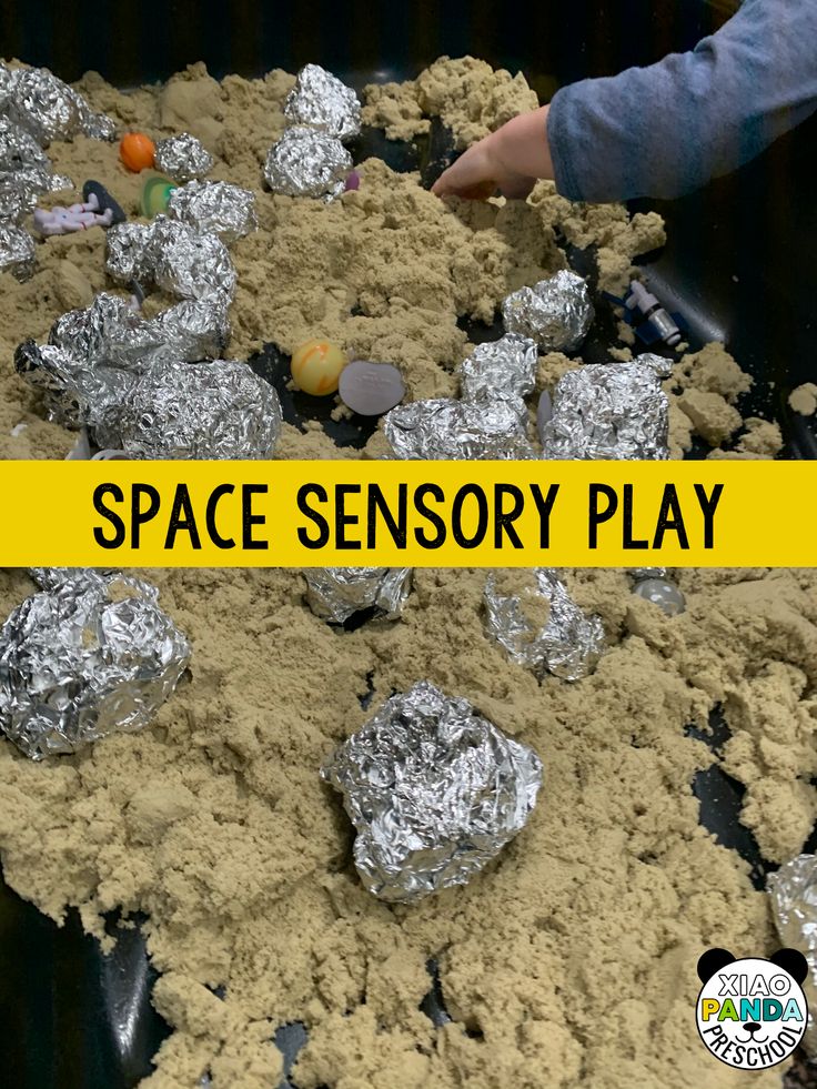 a pile of tinfoil covered rocks with the words space sensory play