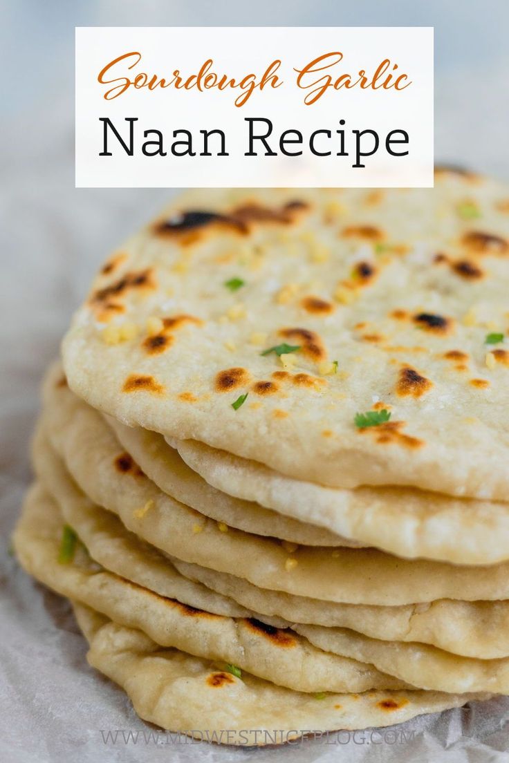 a stack of homemade naan breads with text overlay that reads gourmet garlic naan recipe