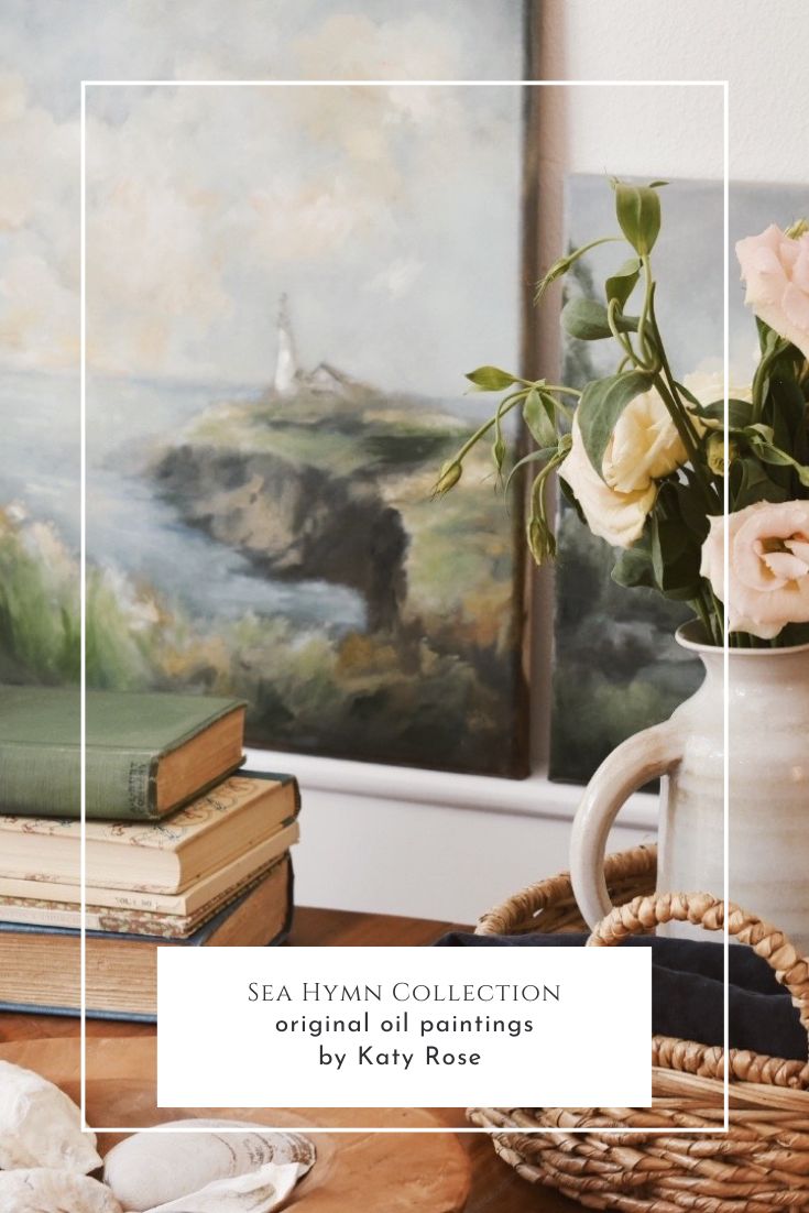 a vase filled with flowers sitting on top of a table next to books and a painting