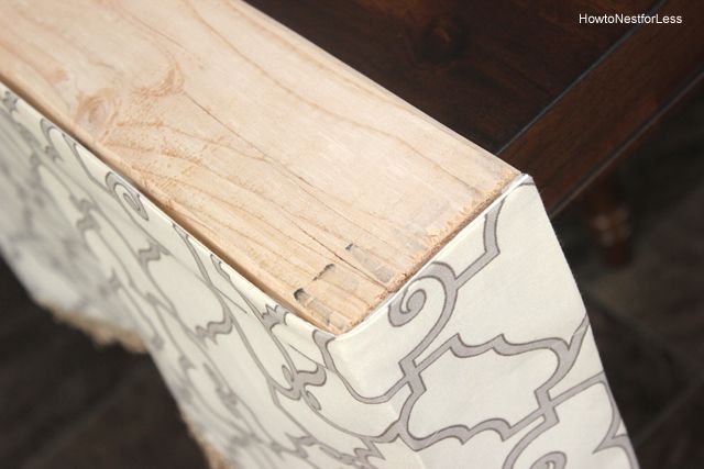 a piece of wood sitting on top of a wooden table next to a chair cushion