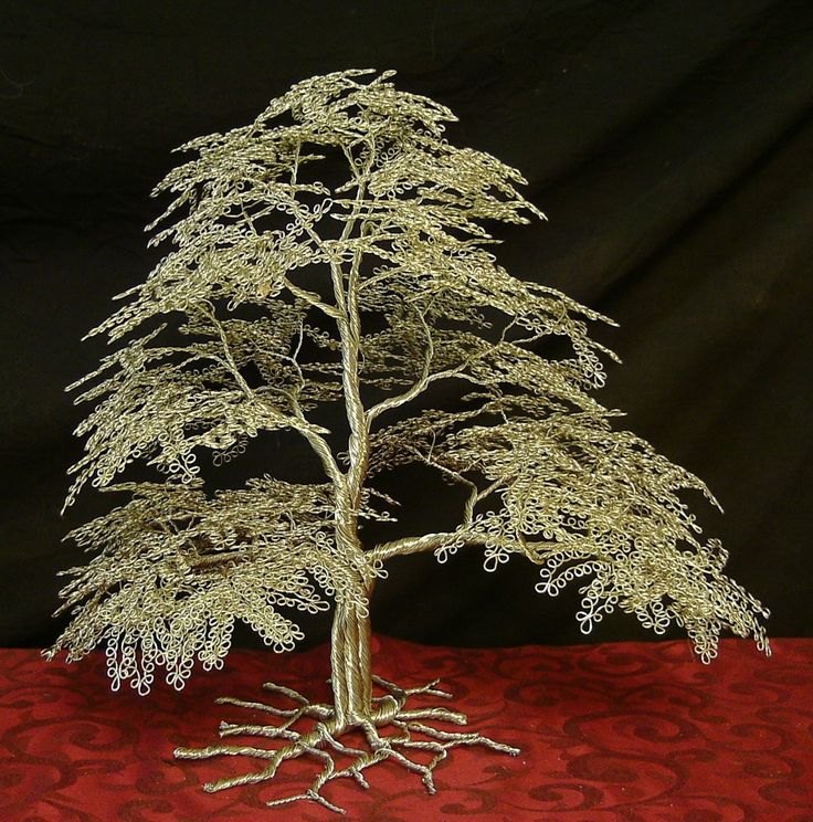 a small white tree sitting on top of a red table