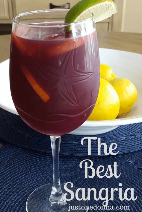 the best sangria is served in a wine glass with lemons on the side