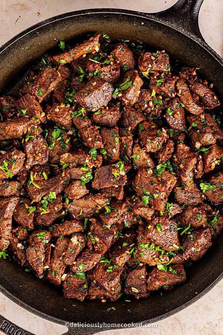 steak in a skillet with parsley on the side, ready to be cooked