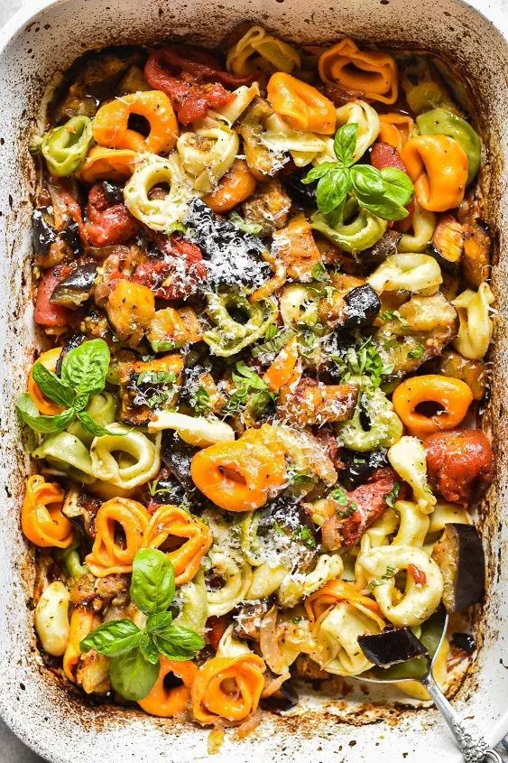 a casserole dish filled with pasta and vegetables