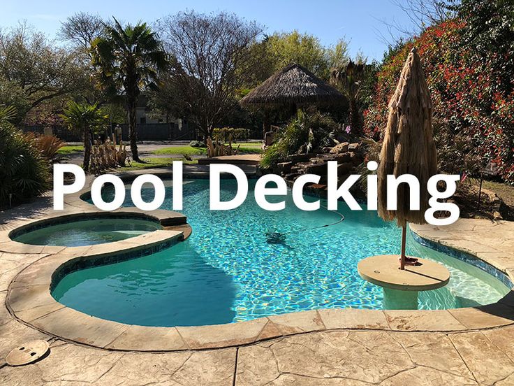 a pool decking area with an umbrella and water features in the background that reads, pool decking