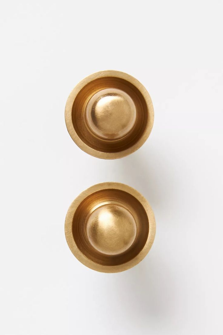 two brass bowls on a white background