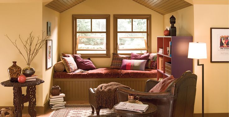 a living room filled with furniture and lots of windows