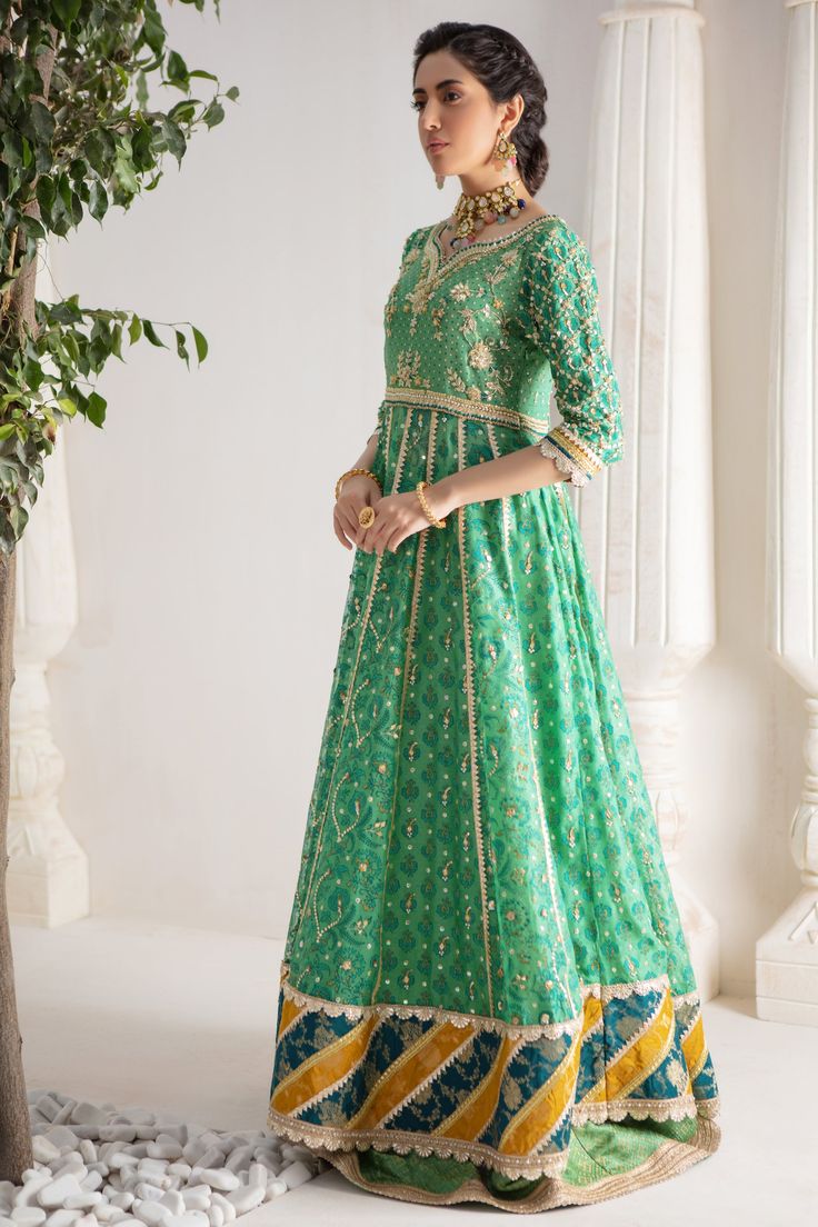 Make a colorful style statement with our beautifully crafted ensemble, gorgeous hand block printed kalidar, heavily embellished with sequins, beads and gota boti chan, neckline and sleeves are beautifully adorned with gorgeous zardozi work, stunning teal & Dhani green hued chata pati appliquéd border on hem finishes it beautifully, gorgeous detailed back and hand-made tassels gives entire outfit a trendy element. This stunning kalidar is offset with jamawar Lehanga and gorgeous Maysuri dupatta featuring gota motifs and heavily embellished chan, trimmed with gota borders , a Must- have wardrobe staple to carry all Wedding Festivities in effortless style. Kalidar Fabric: Pure Silk Net Lehanga Fabric: Jamawar Dupatta Fabric: Pure Maysuri Outfit Color: Opal This outfit is only available in Cus Hem Finishes, Zardozi Work, Designer Outfit, Wedding Festivities, Pakistani Designers, Colorful Style, Style Statement, Colorful Fashion, Pure Silk