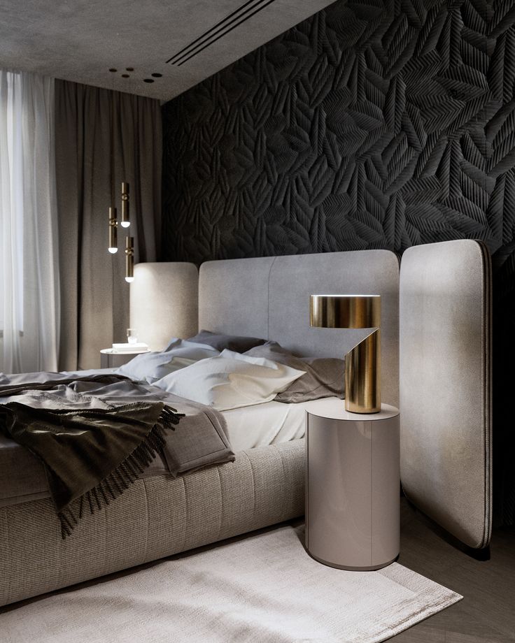 a modern bedroom with black and white walls, gold accents and an upholstered bed