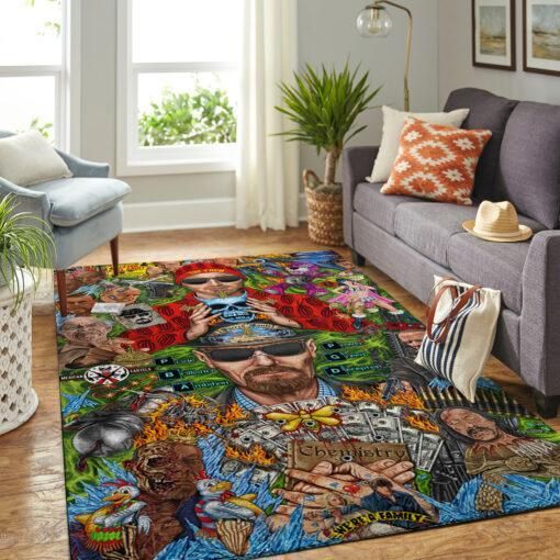 a living room with a couch, chair and rug covered in colorful art on the floor