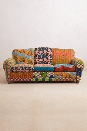 a colorful couch sitting on top of a white floor