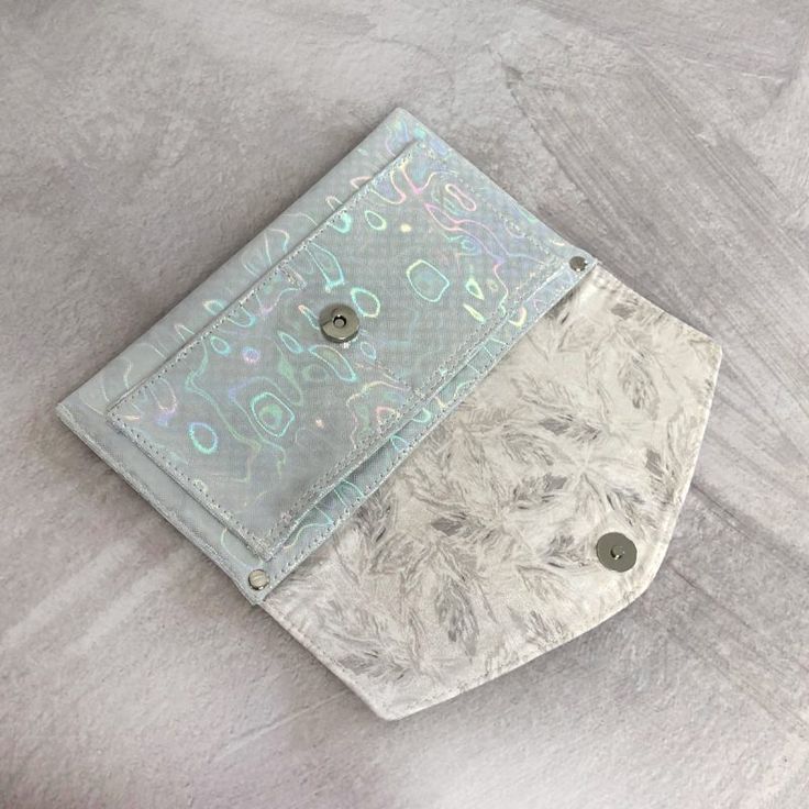 a silver wallet sitting on top of a table