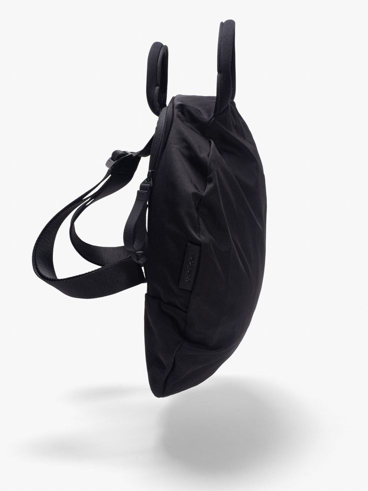 Combining the essential concept of a bag with that of clothing, the MOSELLE is a wearable piece that redefines the lines between wearing and carrying. A detachable keystrap on the side completes this stylish backpack’s silhouette. Made from a ‘Smooth Black’ nylon fabric, that is water-repellent and soft to the touch with a semi-matte finish. Stylish Backpack, Stylish Backpacks, Bag Collection, Recycled Leather, Nylon Fabric, Storage Compartments, Minimalist Aesthetic, Black Nylon, Black Nylons