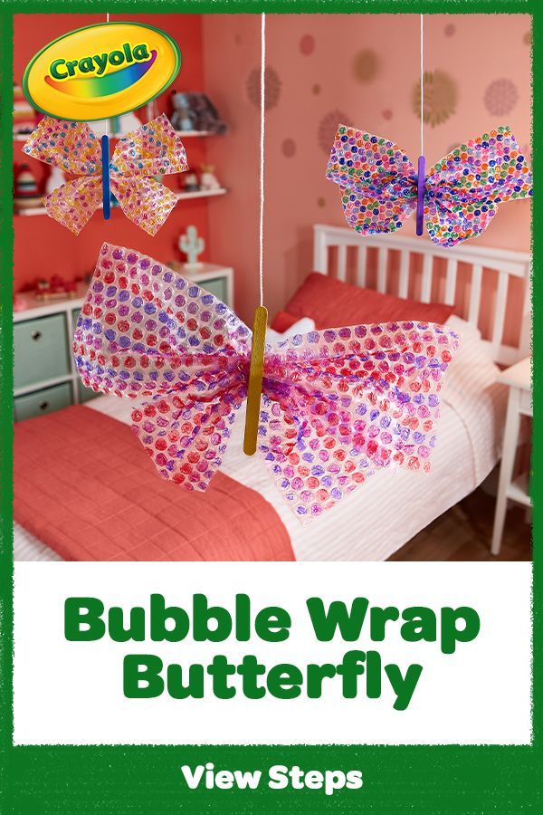 a crayon bubble wrap butterfly hanging from a string in a child's bedroom