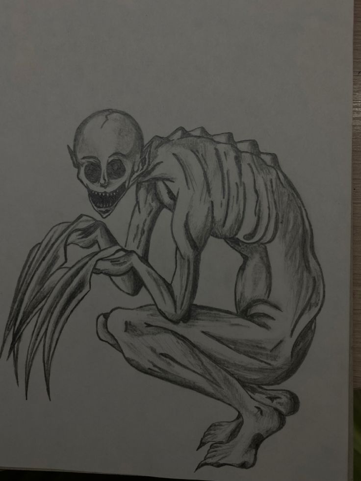 a drawing of a skeleton sitting on top of a piece of paper