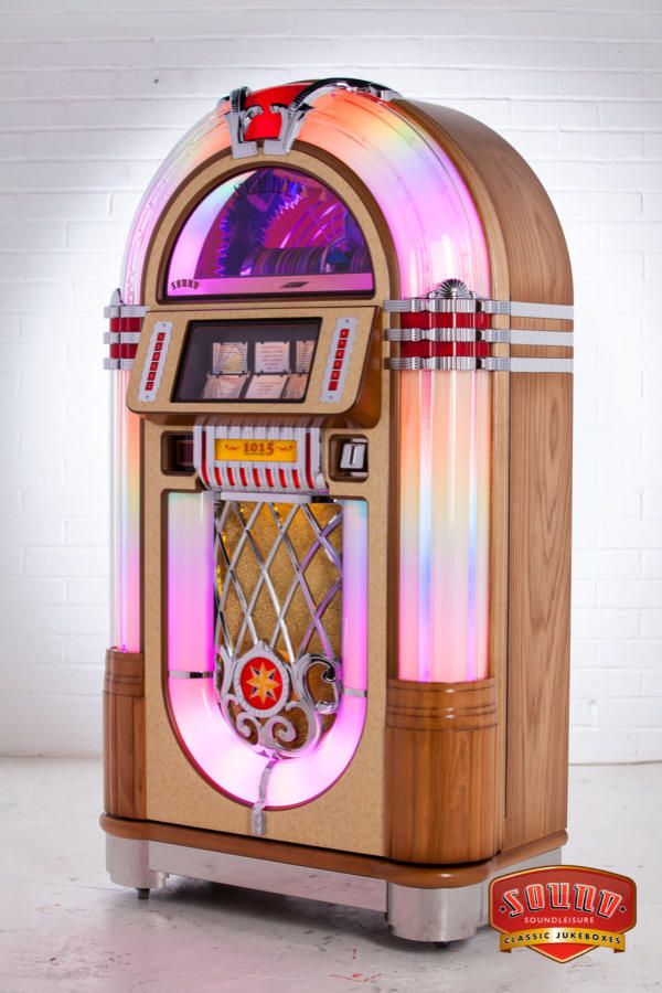 an old fashioned jukebox machine with lights on it's front and sides