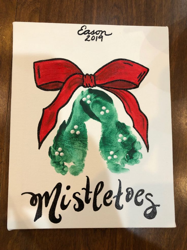 a christmas card with an image of a green handprinted wreath and red bow