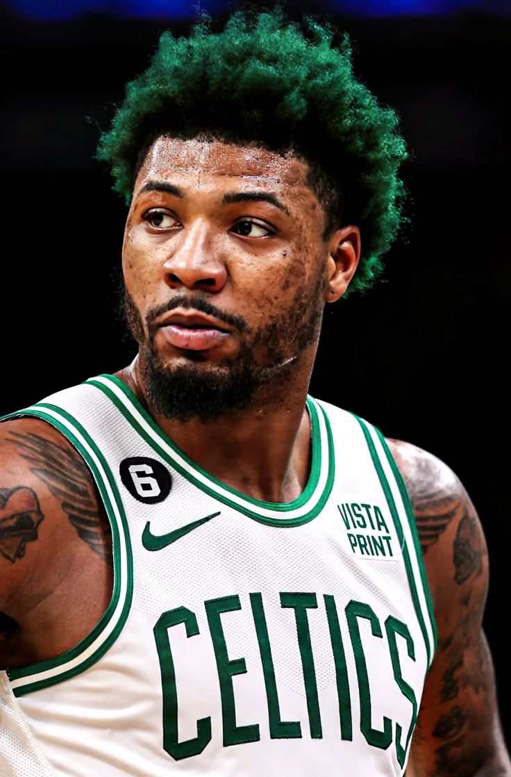 a man with green hair wearing a white jersey