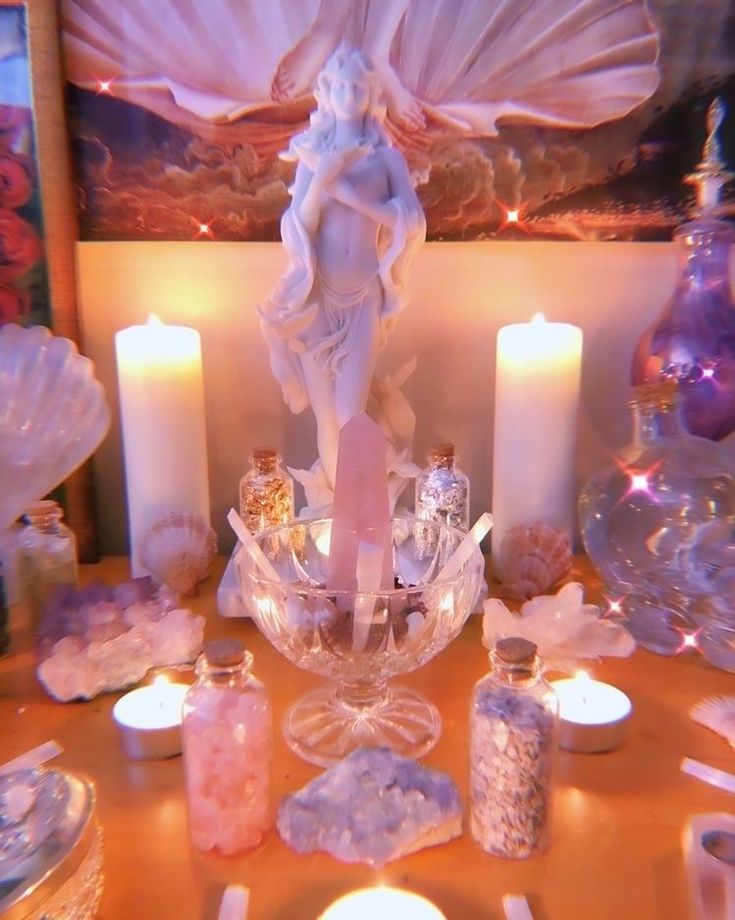 a table topped with candles and angel figurines