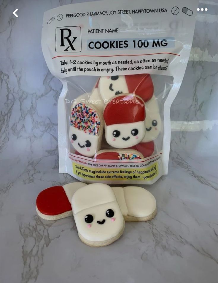 two cookies in the shape of snowmen with sprinkles and hats on them