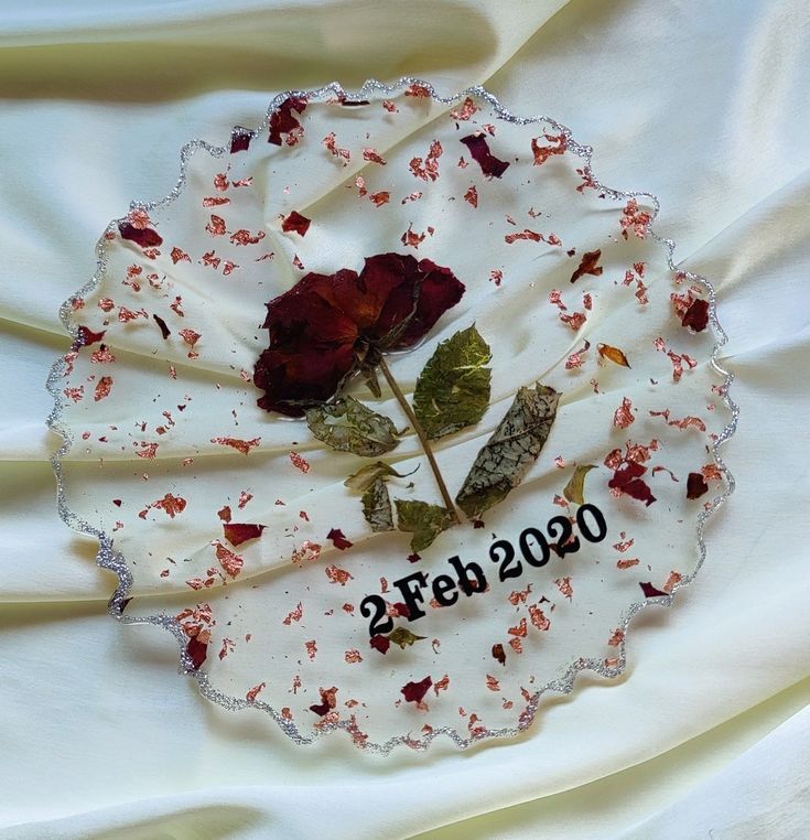 a white plate with red flowers on it and the words 2009 spelled in black letters