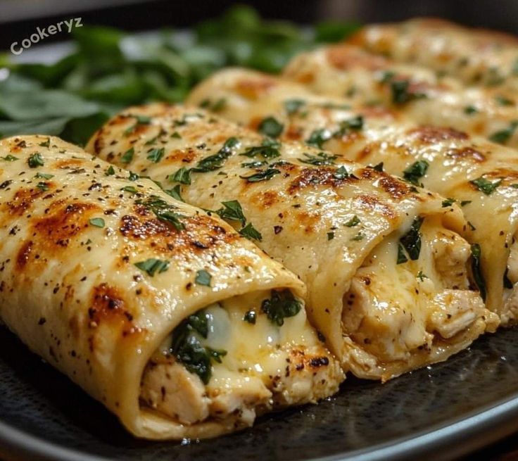 some food is laying on a plate with spinach and other greens in the background