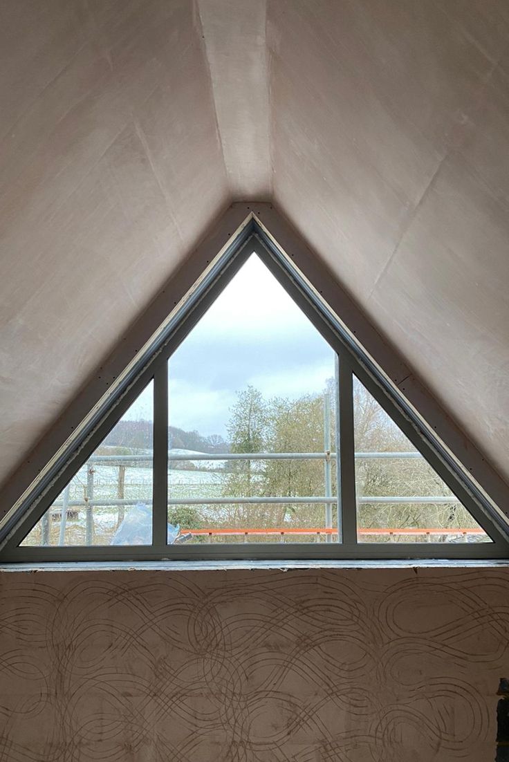 a bed sitting under a window in a bedroom