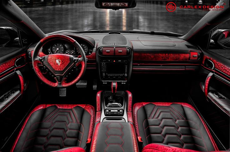 the interior of a sports car with red and black leather trims, steering wheel and center console