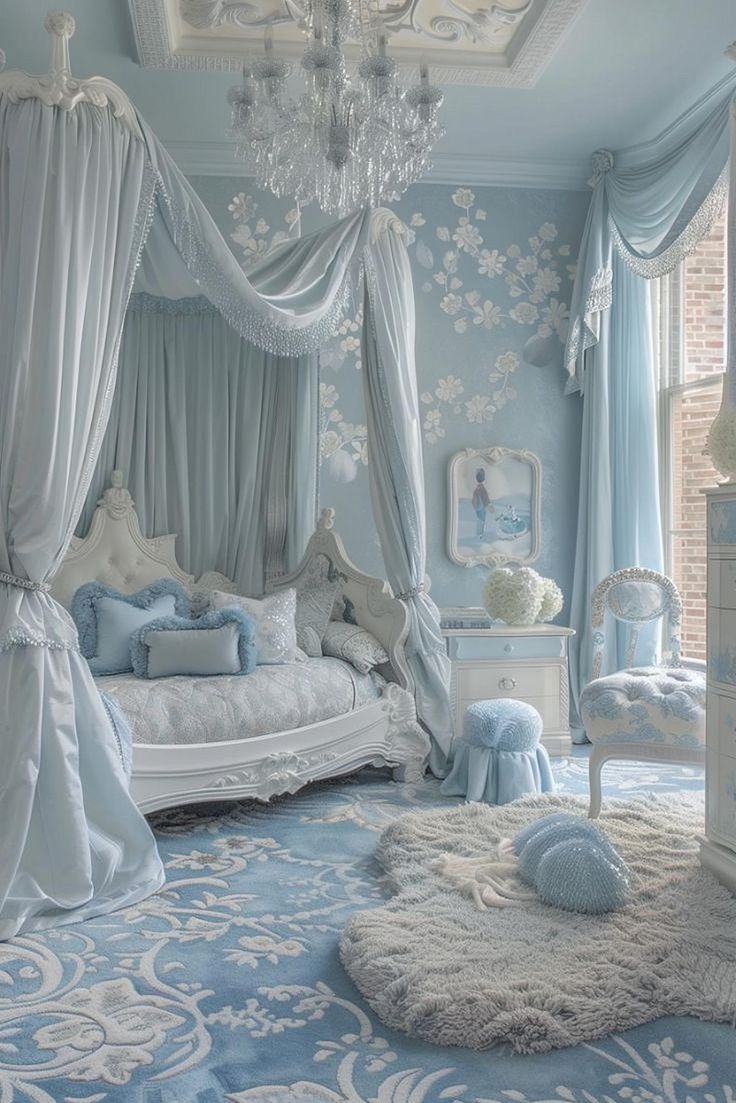 a bedroom decorated in blue and white with a canopy bed, chandelier and rugs