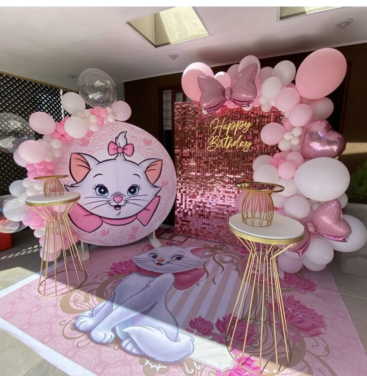 a room decorated with balloons and decorations for a cat themed birthday or baby's first birthday