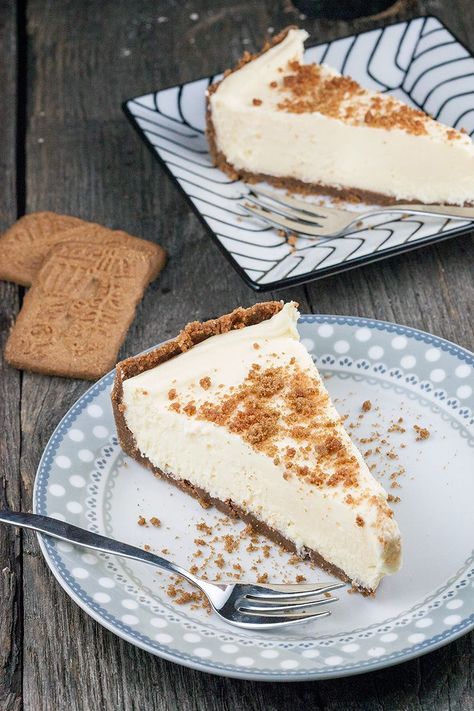 a slice of cheesecake on a plate with a fork next to the rest of the pie