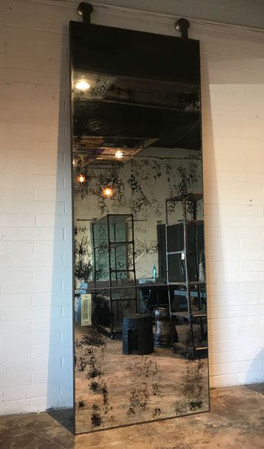 a large mirror sitting in the middle of a room