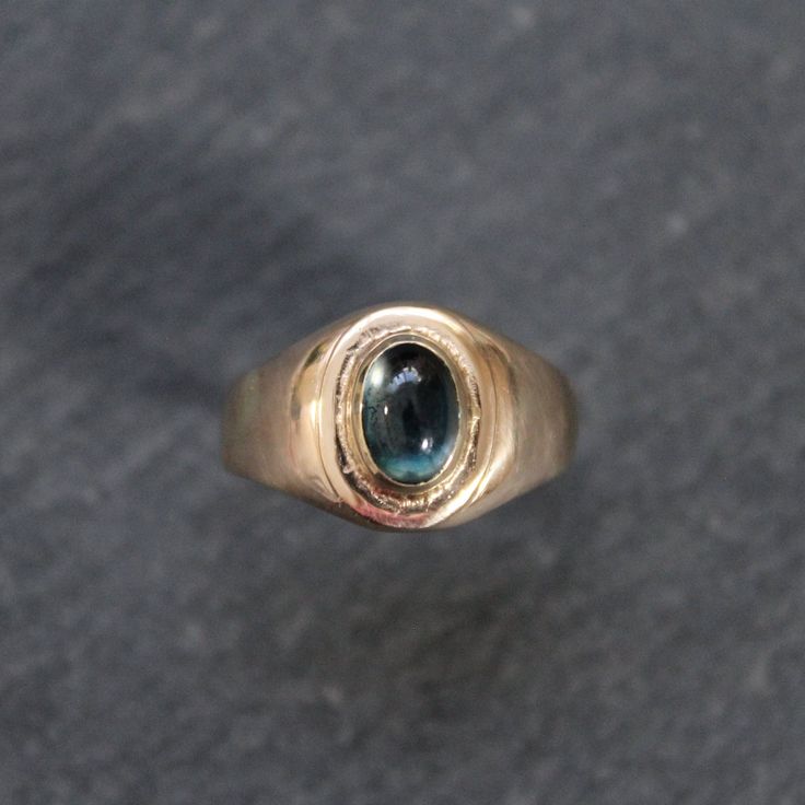 This beautiful 14k yellow gold + London Blue Topaz signet ring features a step style bezel set oval cut cabochon topaz in the center of a yellow gold oval signet ring. Stone Significance:   Blue topaz is believed to promote truth and forgiveness, relaxing the spirit as well as the body.  ⊹ Recycled 14k Yellow Gold + London Blue Topaz ⊹ Excellent vintage, upcycled condition with the exception of a small bend at back of band (ref image) ⊹ Ring Size: 5.75 ⊹ Topaz: 7mm x 5mm Oval Signet Ring, Talisman Pendant, Gold Sun, Ring Stone, Eternity Ring Diamond, Blue Band, Diamond Eternity, London Blue Topaz, London Blue