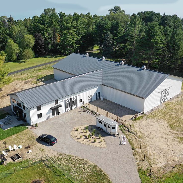 an aerial view of a large white barn