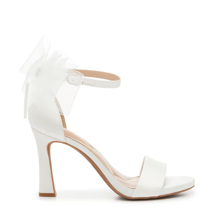 a white high heeled sandal with a bow on the ankle