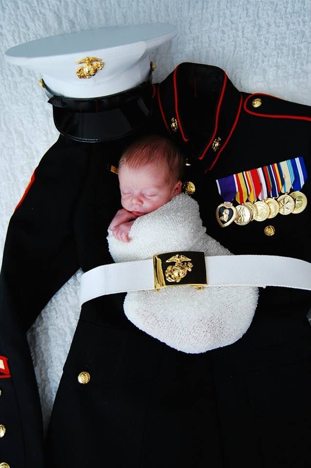 a baby is laying on top of a uniform