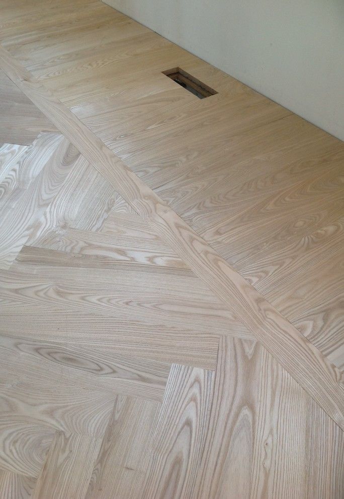 an unfinished wood floor with a hole in the middle