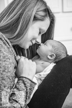 a woman holding a baby in her lap