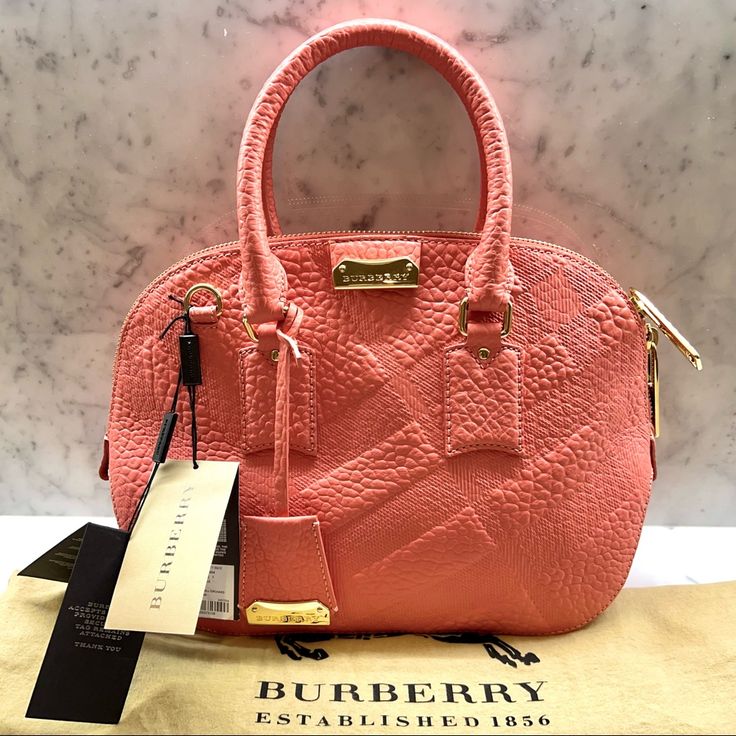 Burberry Check Small Orchard Bag - New With Tags And Dust Bag - Color: Rose Pink - Dimensions: 12”L X 9.75”H X 3.75”W - Burberry Check Grained Leather - Double Zip Closure - Removable Adjustable Shoulder Strap - Gold Hardware - Inner Pocket With Zip Closure - Two Open Inner Pockets Reasonable Offers Only Please! Luxury Pink Pouch-shaped Satchel, Luxury Pink Pouch Satchel, High-end Pink Satchel With Detachable Handle, Designer Pink Satchel For Formal Occasions, Designer Pink Satchel With Handle Drop, Designer Pink Satchel With Gold-tone Hardware, Small Orchard, Rose Pink, Gold Hardware