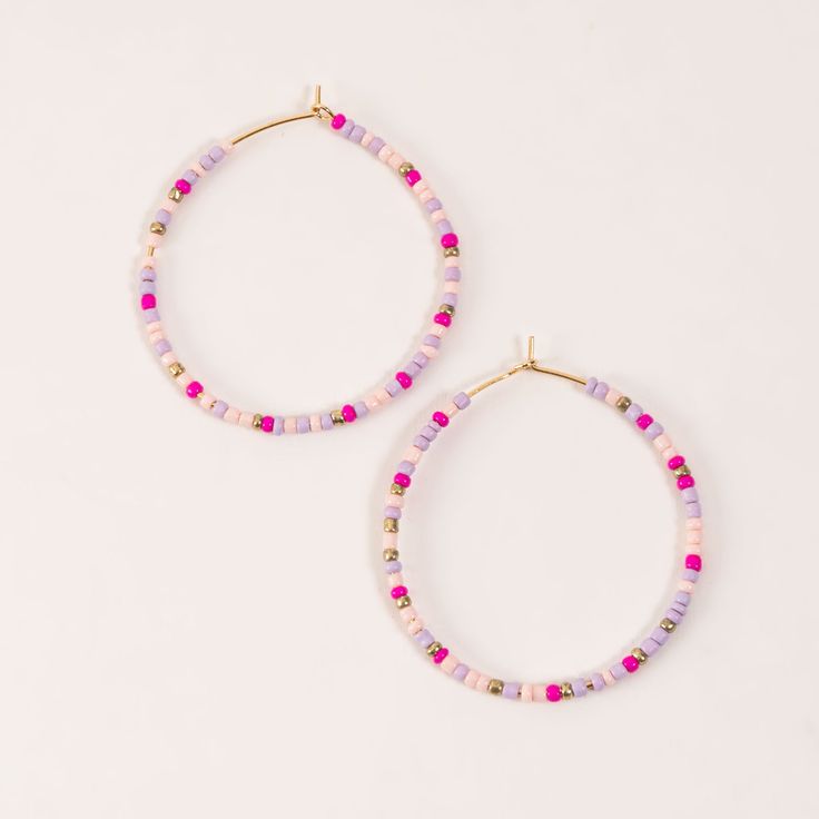 Add a bit of color to your wardrobe with the Ashli Beaded Hoop Earrings. Beaded with various shades of pinks, creams, and lavender, these delicate seed bead hoop earrings bring both style and interest to any outfit. Fish Hook with rubber backing Nickel Free Hypoallergenic Beaded Hoop Earrings For Spring, Pink Beaded Earrings For Spring, Spring Beaded Hoop Earrings, Purple Beaded Hoop Earrings With Round Beads, Purple Beaded Hoop Earrings, Trendy Small Hoop Beaded Earrings With Tiny Beads, Pink Hoop Beaded Earrings, Trendy Pink Beaded Earrings With Round Beads, Trendy Pink Hoop Earrings With Round Beads