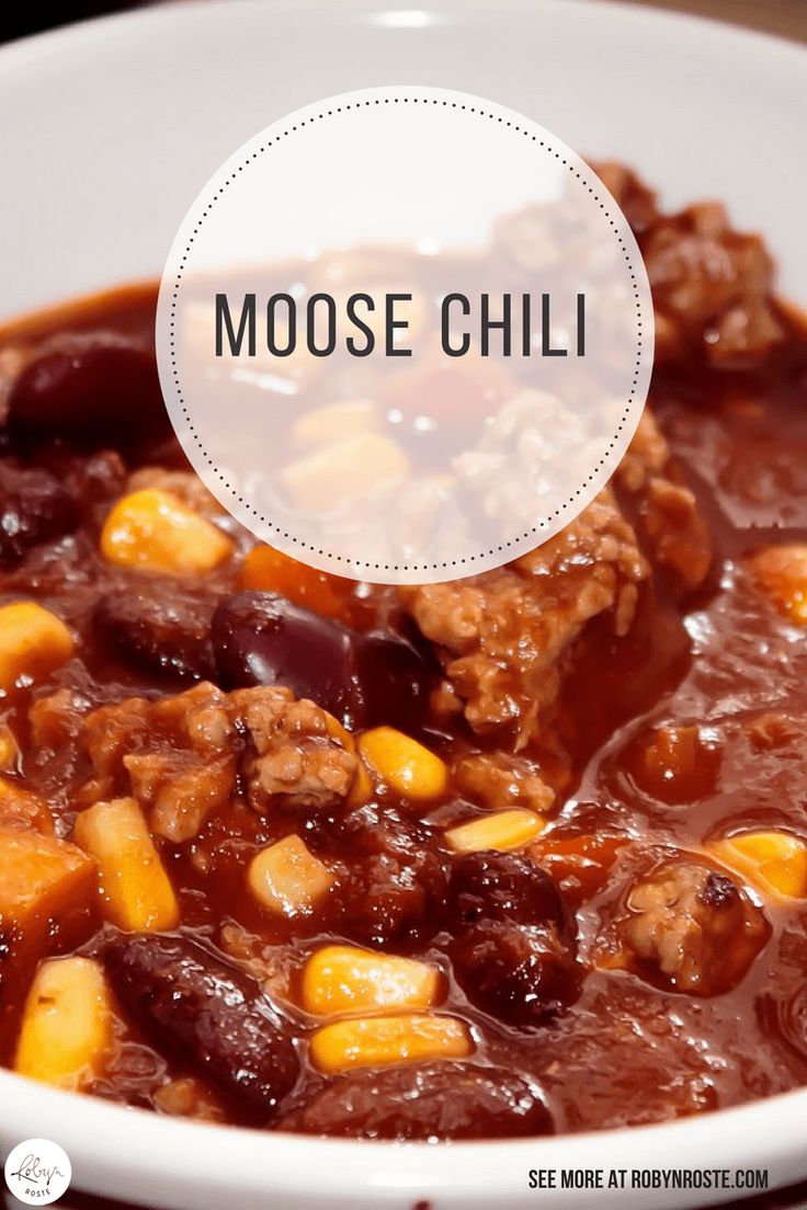 a close up of a bowl of food with the words moose chili in front of it