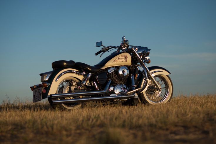 a motorcycle is parked in the middle of a field