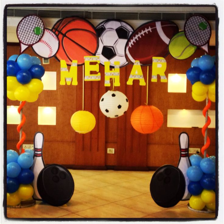 a room decorated with balloons and sports balls