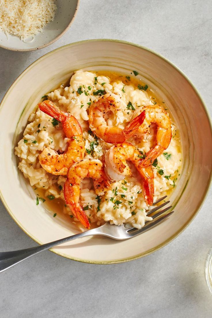 shrimp and grits served in a bowl with a fork