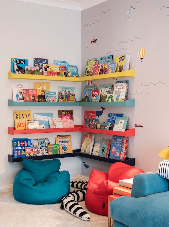 a child's room with bookshelves and bean bag chairs