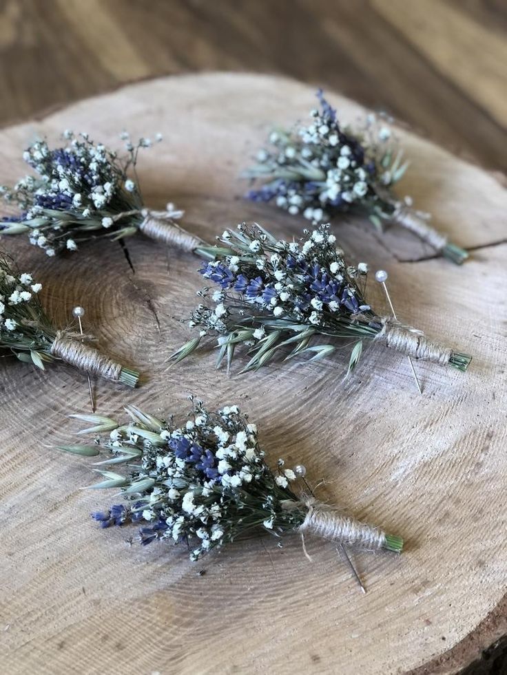 four small bouquets of lavender on a wood slab with white and blue flowers in the center