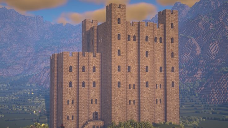 a very tall castle sitting on top of a lush green hillside